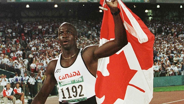 donovan-bailey-holds-canadian-flag.jpg