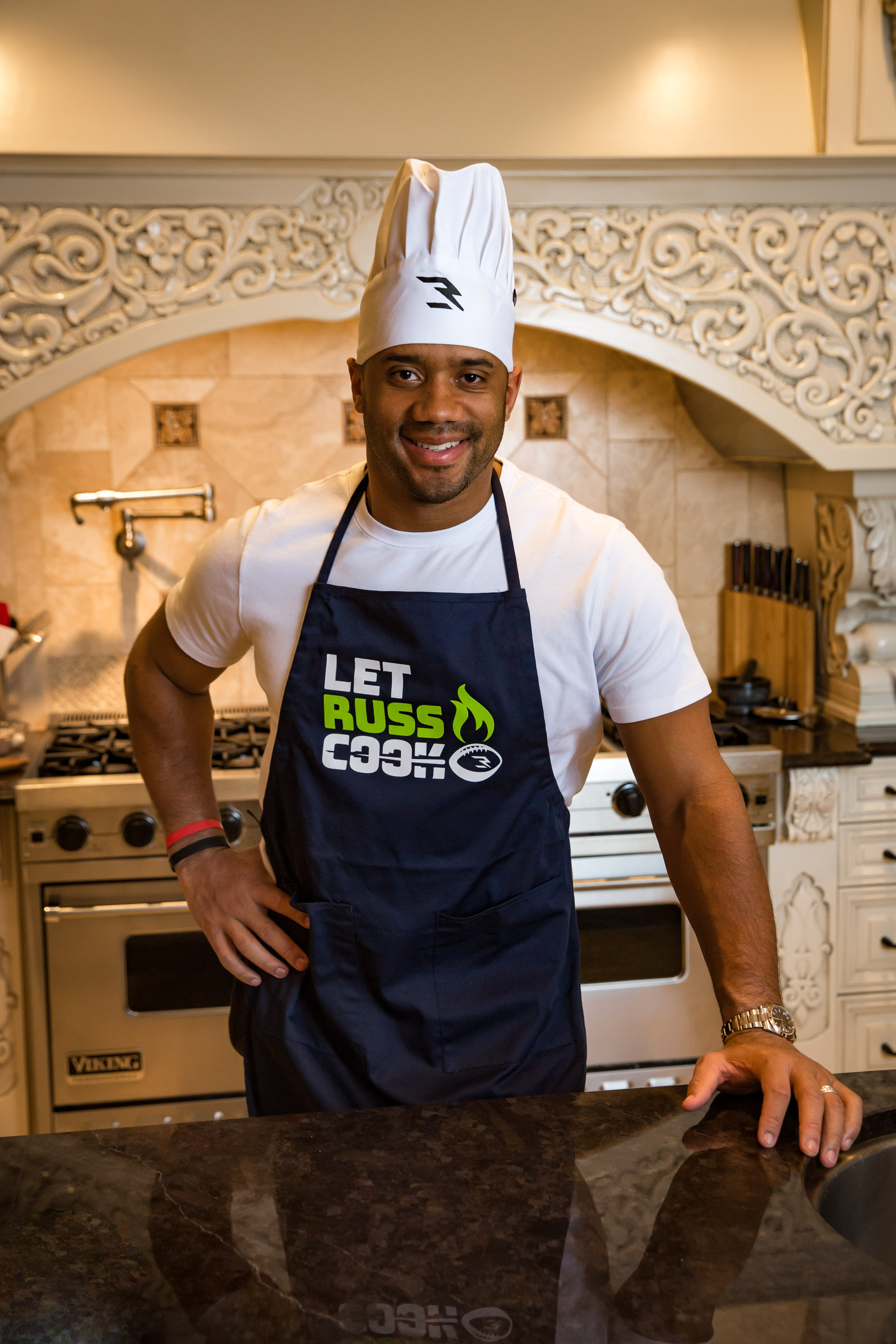 Russell-Wilson-in-Why-Not-You-Foundation-Apron.jpg