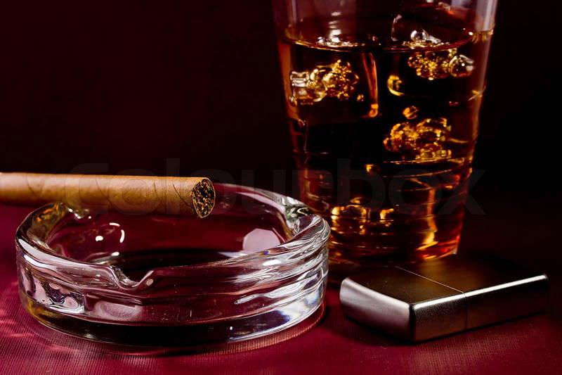 2871062-260428-close-up-selective-focus-of-a-brown-cigar-and-silver-lighter-with-a-glass-of-whiskey-in-the-background.jpg